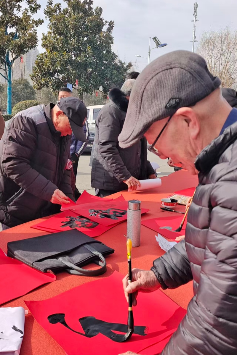 江苏省徐州市铜山区新区街道驿城村关工委组织“五老”为群众义务写春联
