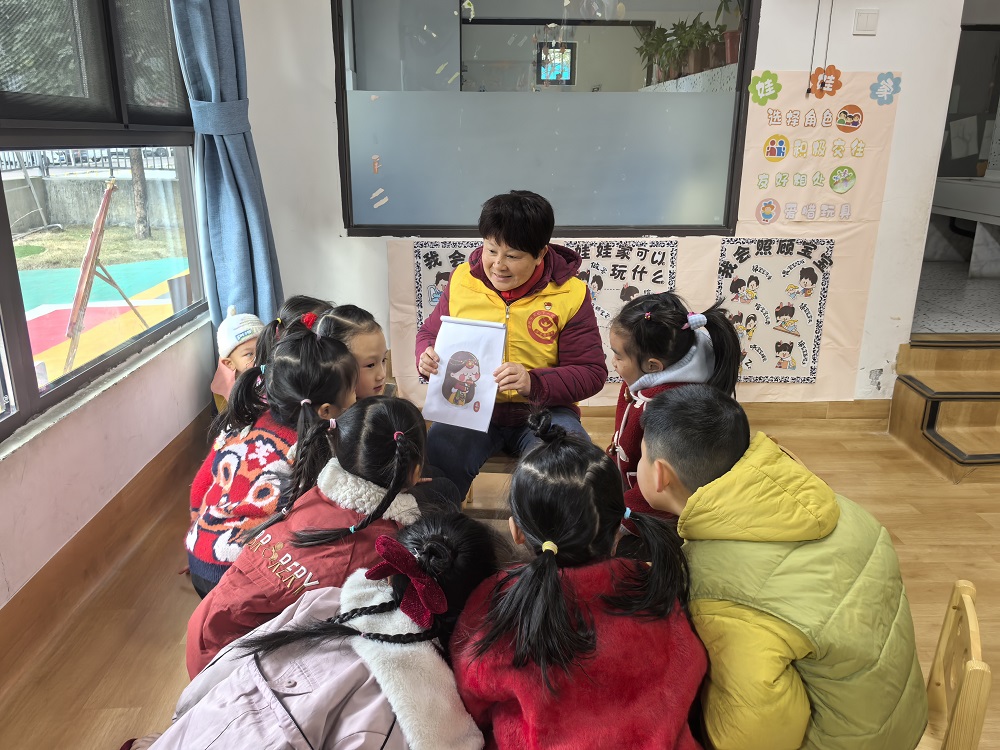 1736757273664444.jpg “五老”志愿者给小朋友介绍我国的民族服饰1.jpg