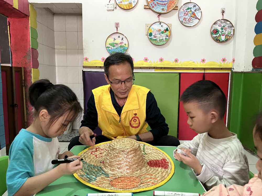 1746003226962794.jpg “五老”和青少年一起绘画草帽.jpg