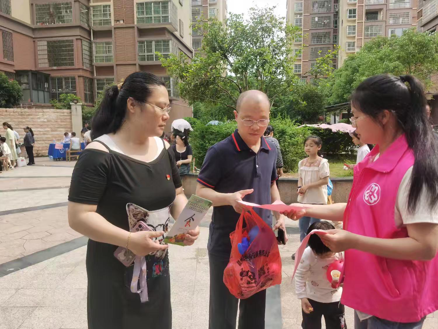 1747971565230910.jpg 志愿者向儿童家长发放宣传册.jpg